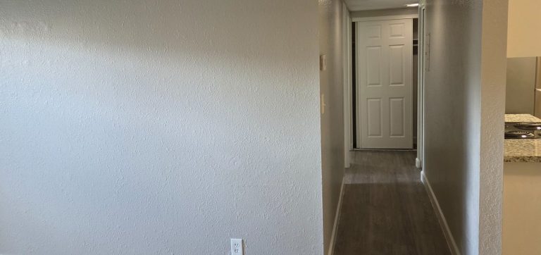 Hallway with painted walls and wood-look flooring